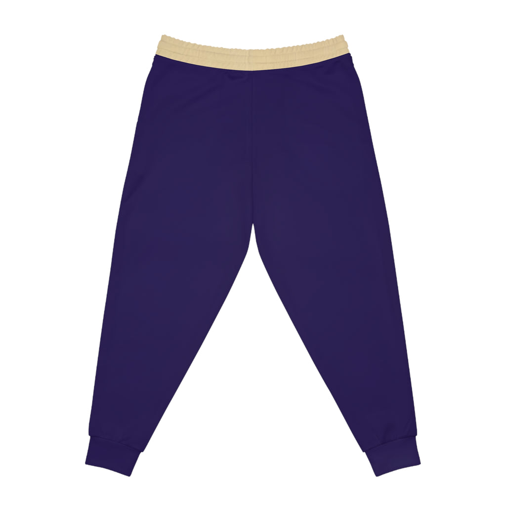 A pair of dark purple jogger pants with a contrasting beige elastic waistband, shown flat against a solid white background.