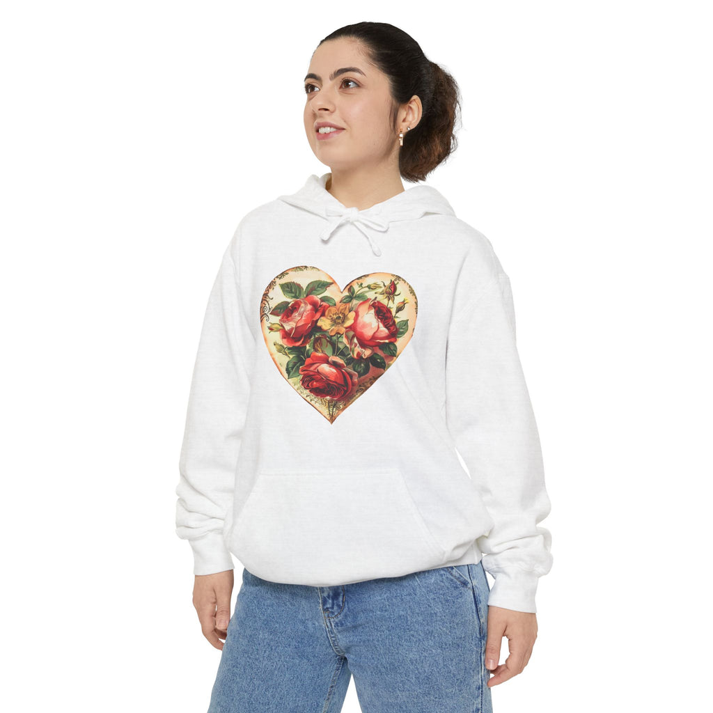 Person wearing a white hoodie with a floral heart design on a white background