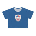 A royal blue short-sleeve crop top t-shirt featuring a USA shield crest graphic on the chest, displayed against a solid white background.