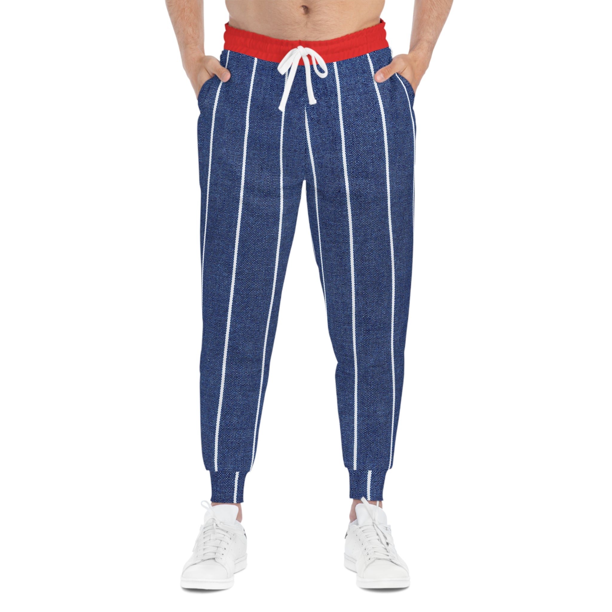 A person wearing blue pinstriped jogger pants with a red waistband and white drawstring, paired with white sneakers, shown against a plain white background.