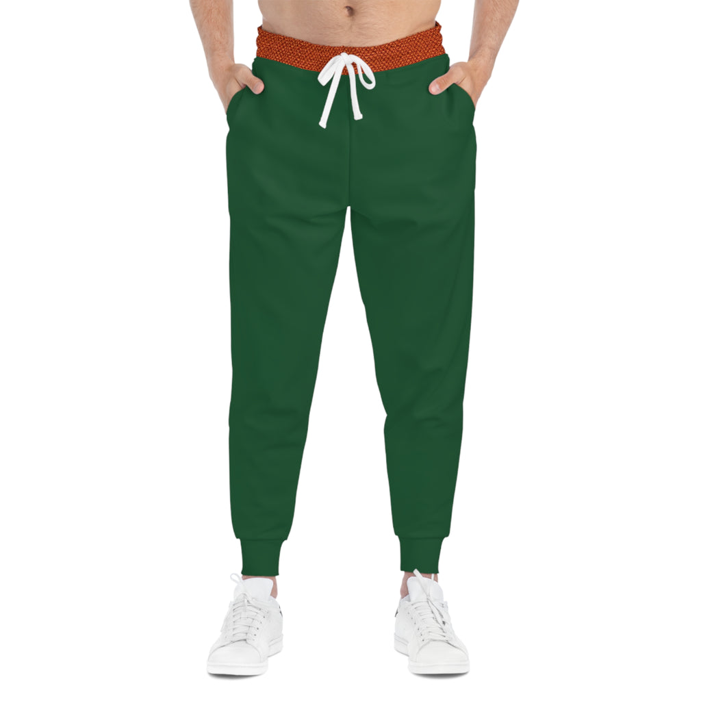 A person wearing dark green jogger sweatpants with a textured orange-red waistband, white drawstring, and white sneakers, shown from the waist down on a plain white background.