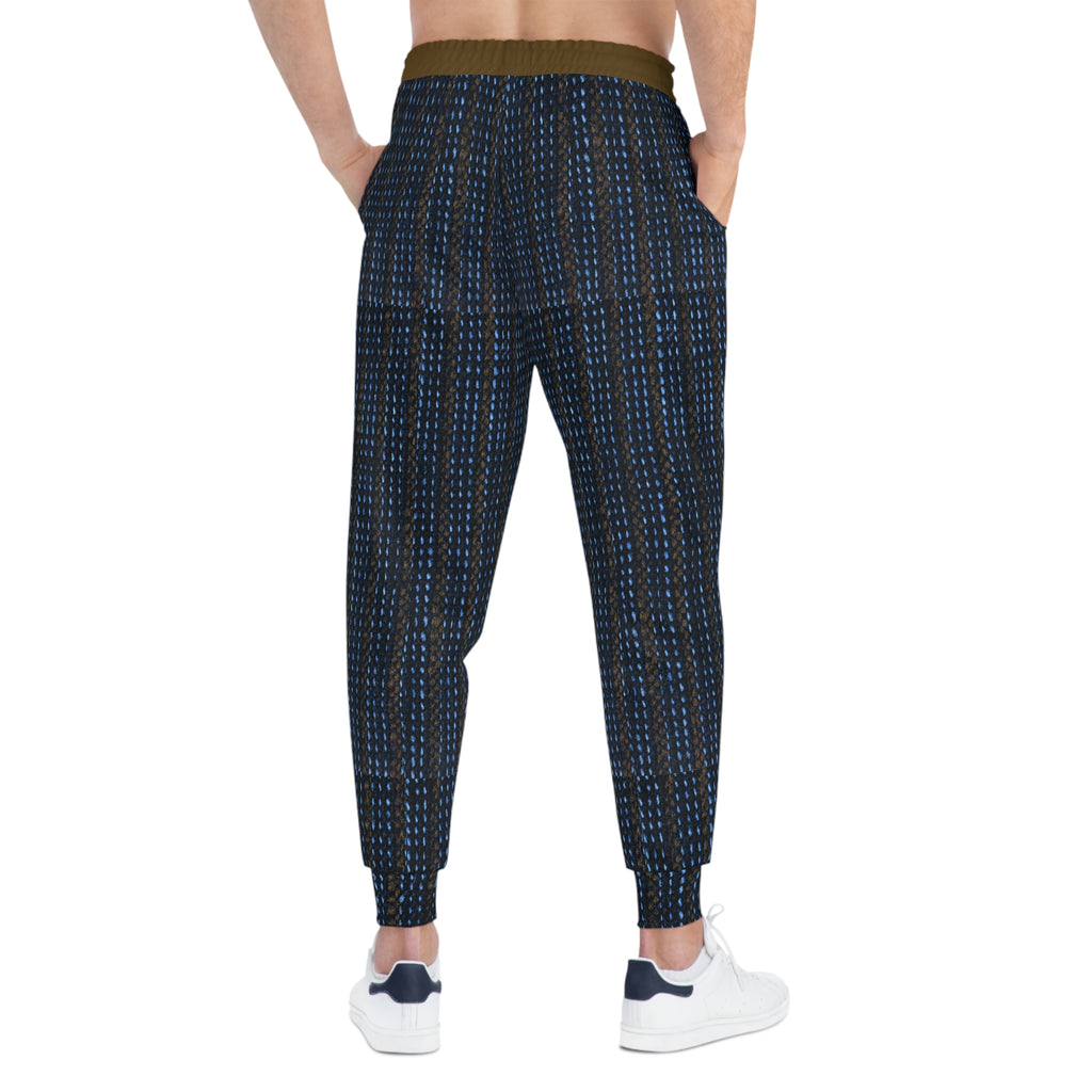 A person shown from the back wearing patterned jogger-style pants with a dark navy base and small blue and white vertical dotted lines, plus a contrasting olive-brown waistband and white sneakers.