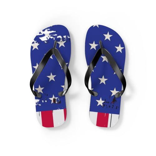 A pair of flip-flop sandals with a distressed American flag design, featuring blue straps with white stars and red and white stripes at the toe, shown on a white background.