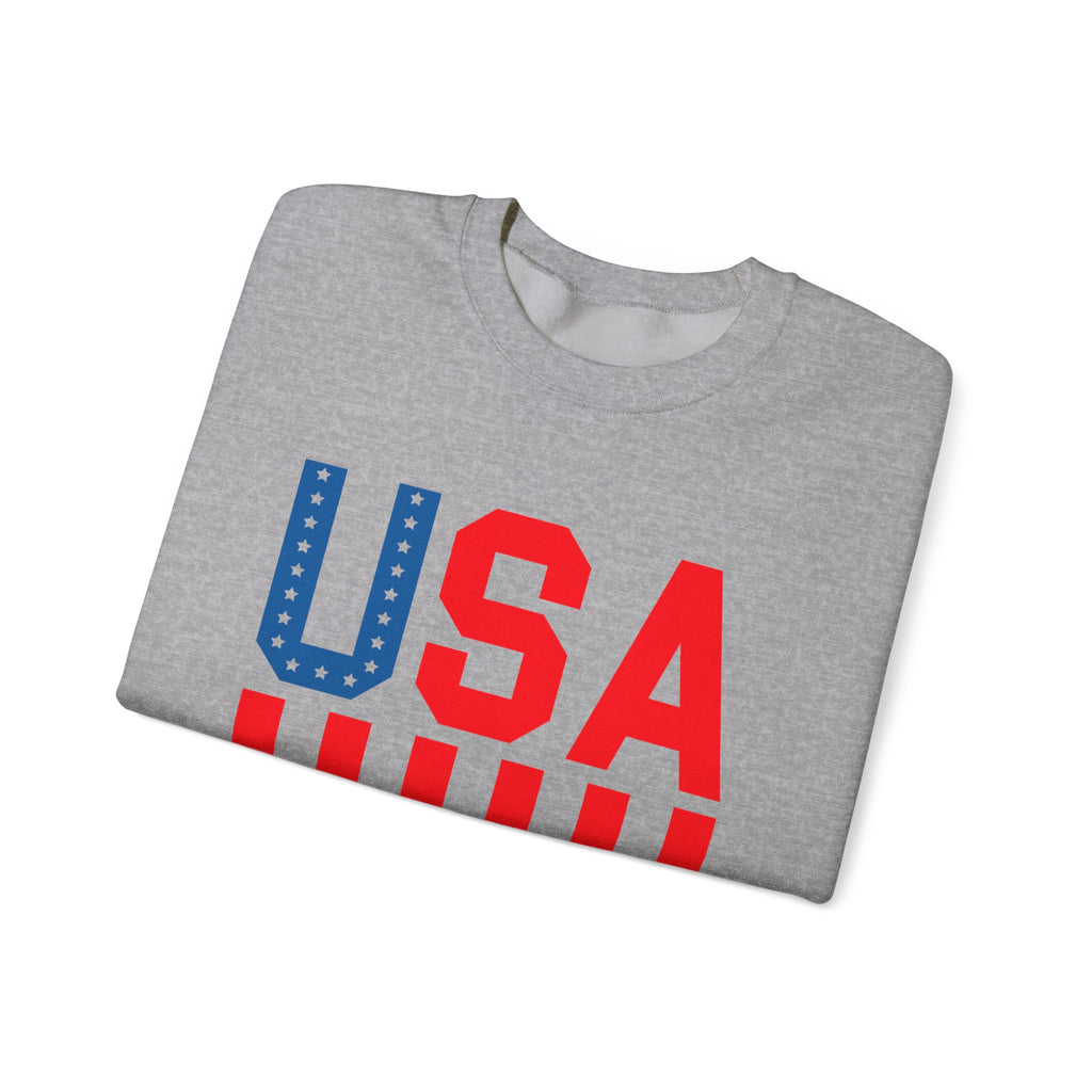 A folded heather gray crewneck sweatshirt featuring a bold 'USA' graphic on the front in red and blue with white stars and stripes details, set against a plain white background.