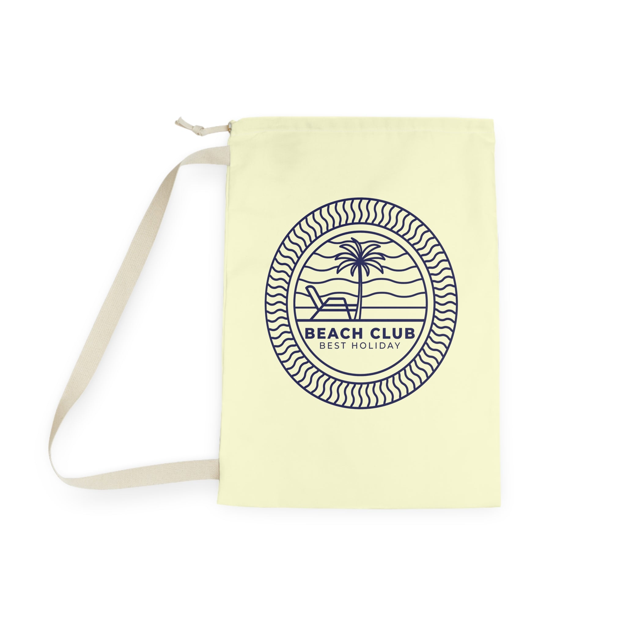 A pale yellow canvas tote bag with a beige shoulder strap, featuring a navy blue circular graphic on the front with a palm tree, beach chair, and the text 'BEACH CLUB BEST HOLIDAY'.
