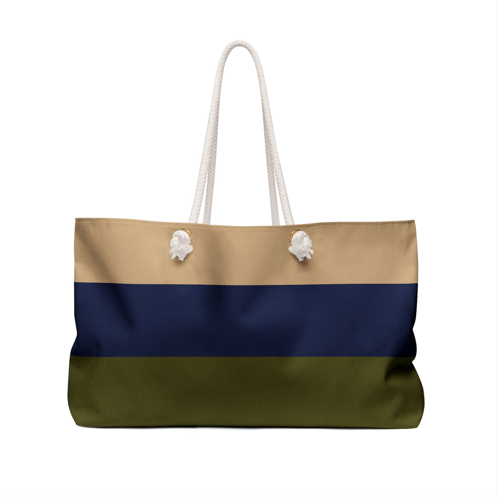 A horizontal-striped tote bag with white rope handles, featuring three color bands: beige on top, navy blue in the middle, and olive green on the bottom, with small white decorative accents near the top.