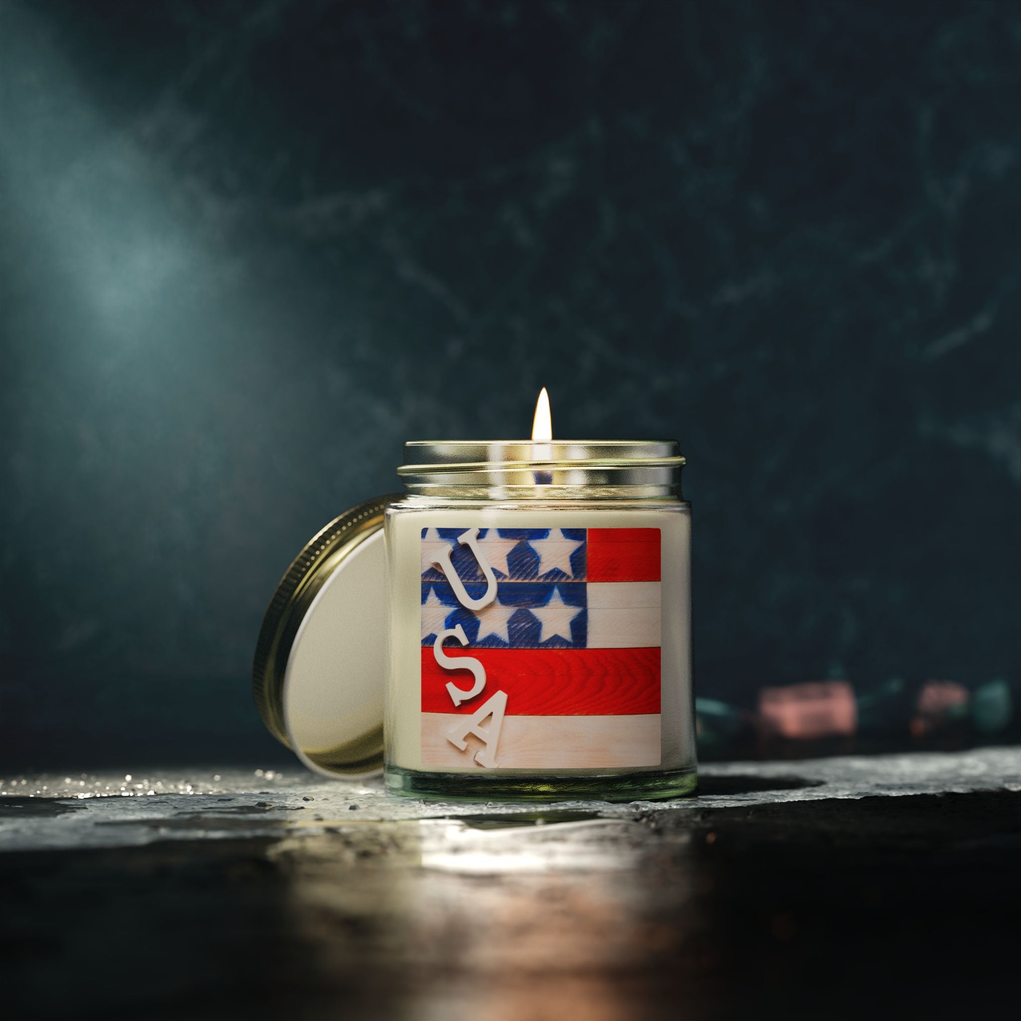 Candle in a jar with an American flag design on a dark background