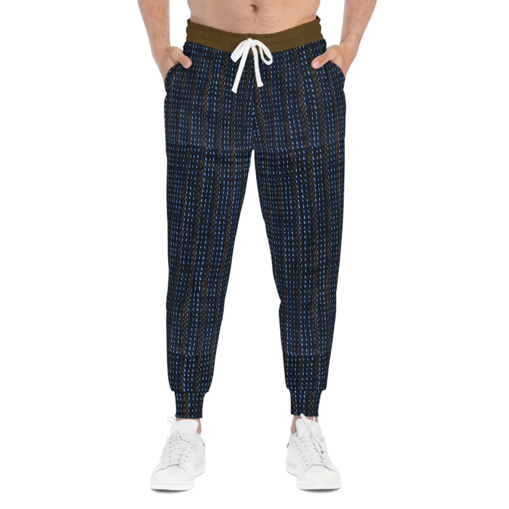 A person wearing dark navy jogger-style pants with a small white and blue geometric pattern, an olive green waistband, and a white drawstring, paired with white sneakers against a plain white background.