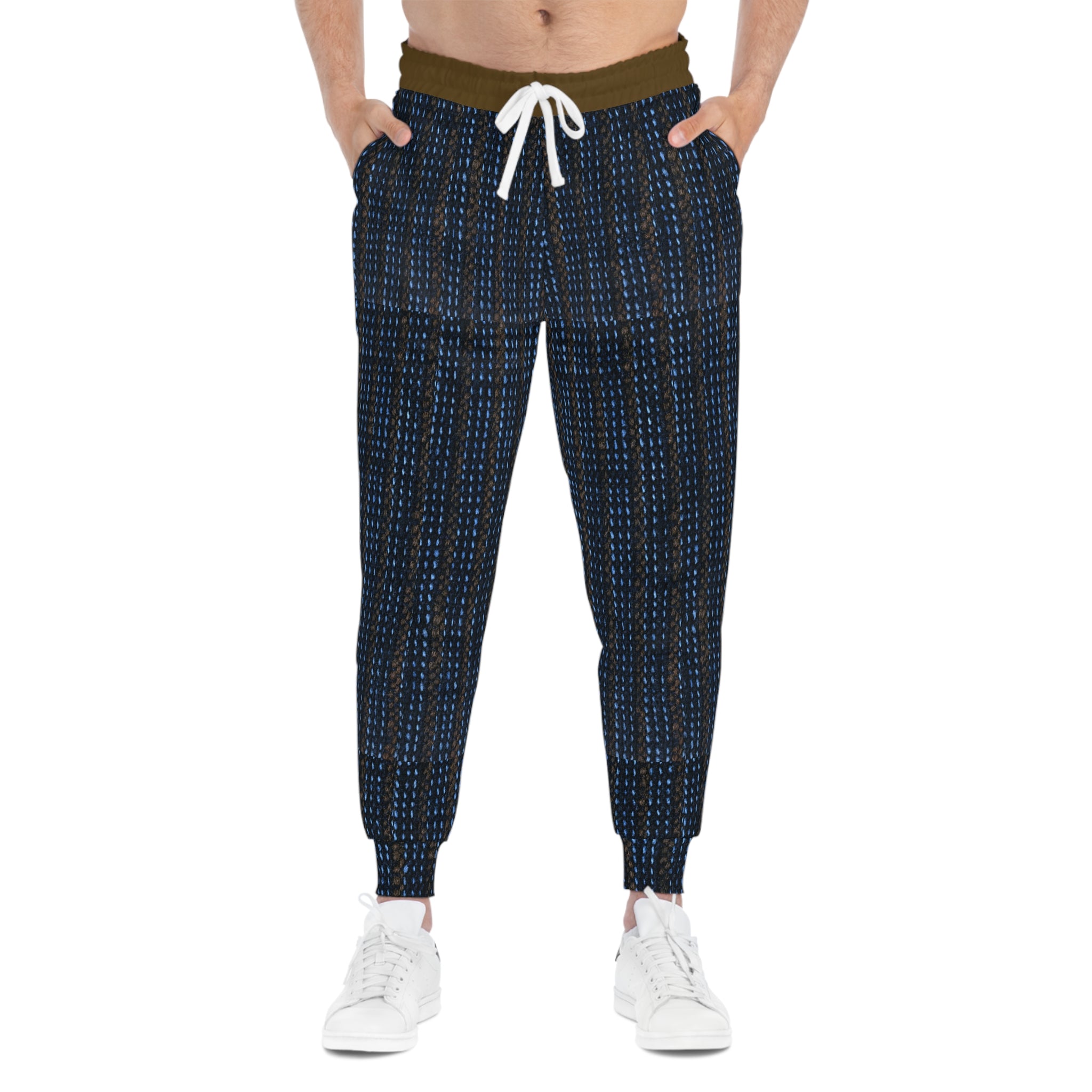 A person wearing dark navy jogger-style pants with a small white and blue geometric pattern, an olive green waistband, and a white drawstring, paired with white sneakers against a plain white background.