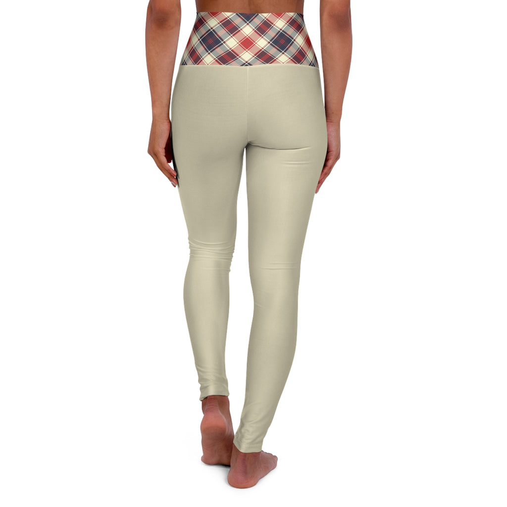 Rear view of a model wearing high-waisted beige leggings with a red, blue, and white plaid waistband, standing barefoot against a white background.