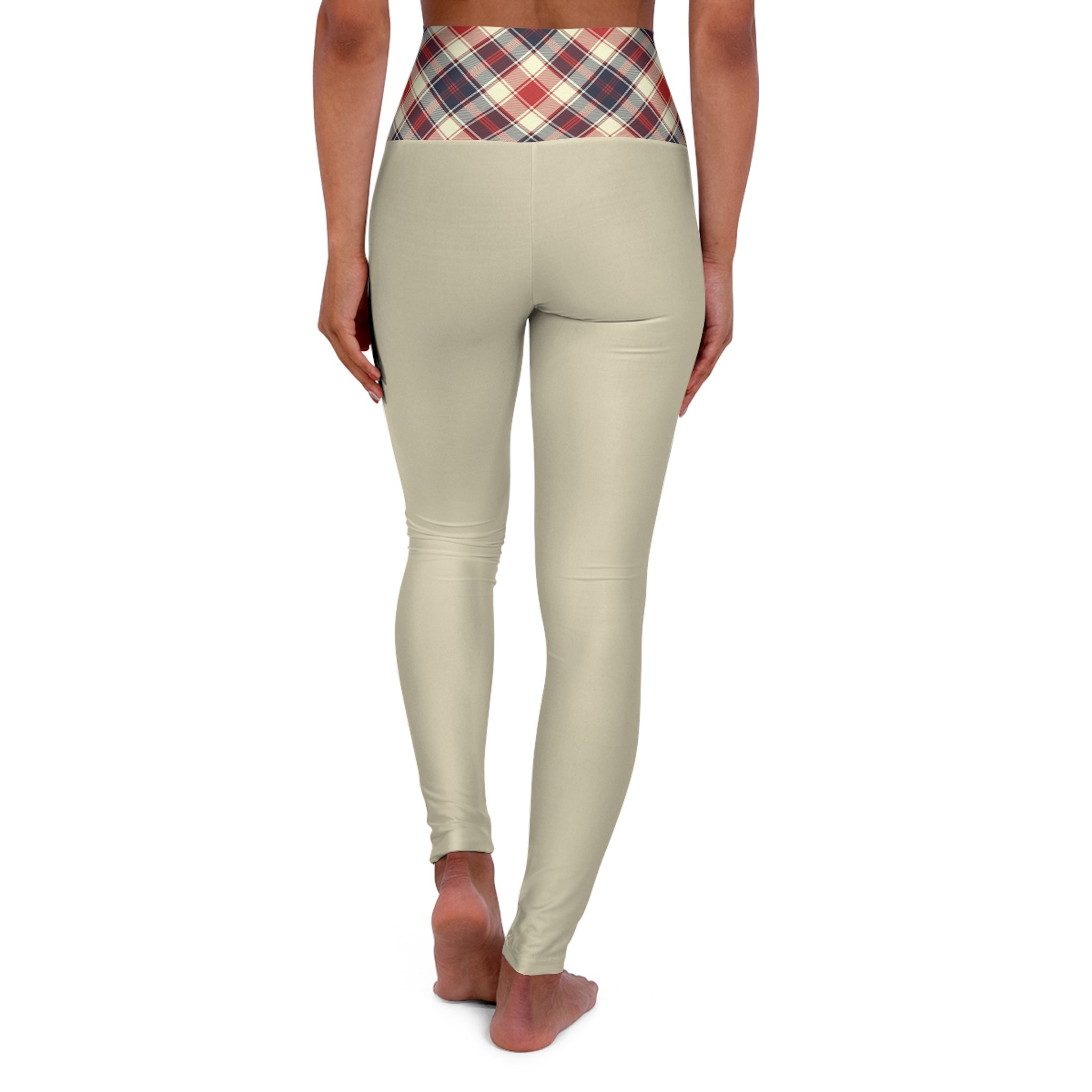 Rear view of a model wearing high-waisted beige leggings with a red, blue, and white plaid waistband, standing barefoot against a white background.