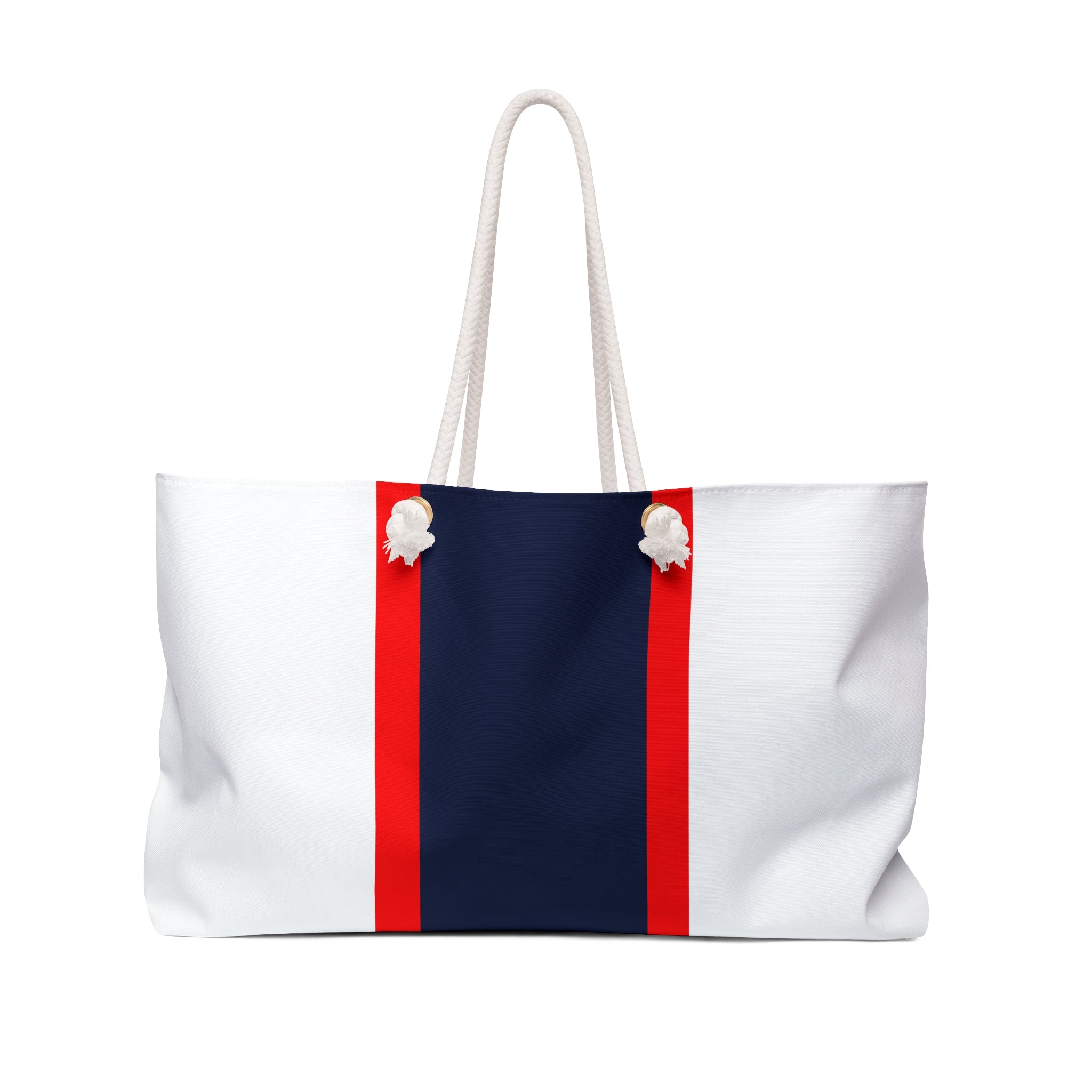 A white tote bag with a bold navy blue center panel and two vertical red stripes flanking the panel. The bag has white rope handles and decorative white shell-like accents near the top corners.