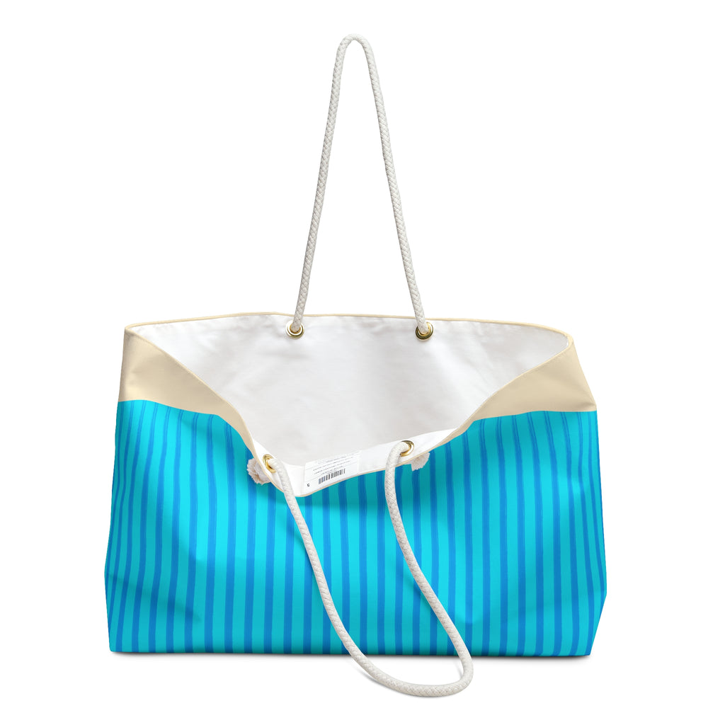 A large tote bag with a bright blue and white vertical stripe pattern on the lower half, a solid white upper panel, beige side panels, and thick white rope handles, shown on a plain white background.
