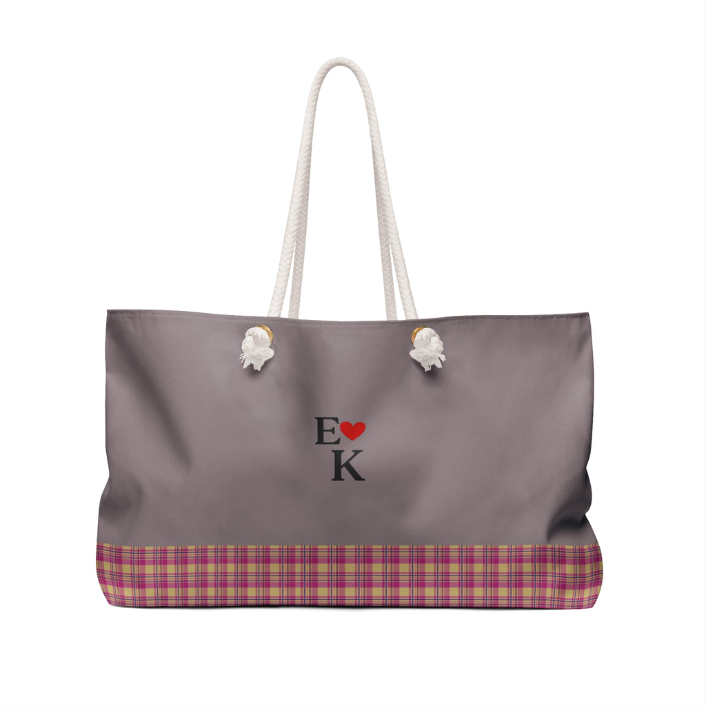 A gray tote bag with white rope handles, featuring a pink and purple plaid bottom border and a central 'E [red heart] K' monogram design, shown on a plain white background.
