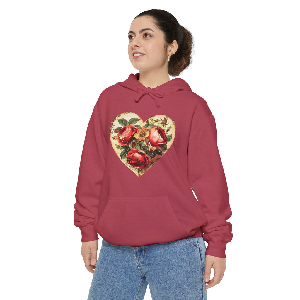 Person wearing a red hoodie with a floral heart design on a white background