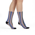 Colorful striped socks worn by a person on a white background