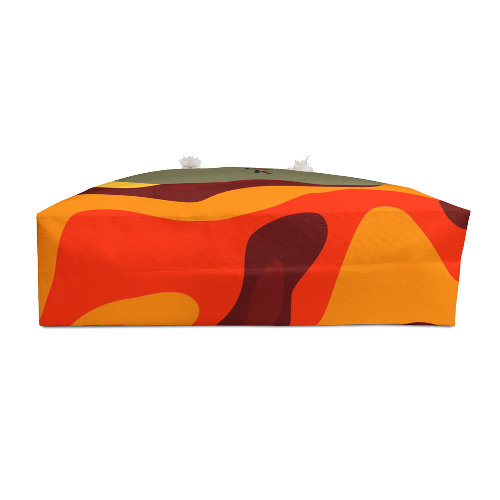 A rectangular tissue box cover featuring an abstract wavy pattern in orange, red, yellow, and dark brown, with a small olive green band at the top and white tissue tips visible.