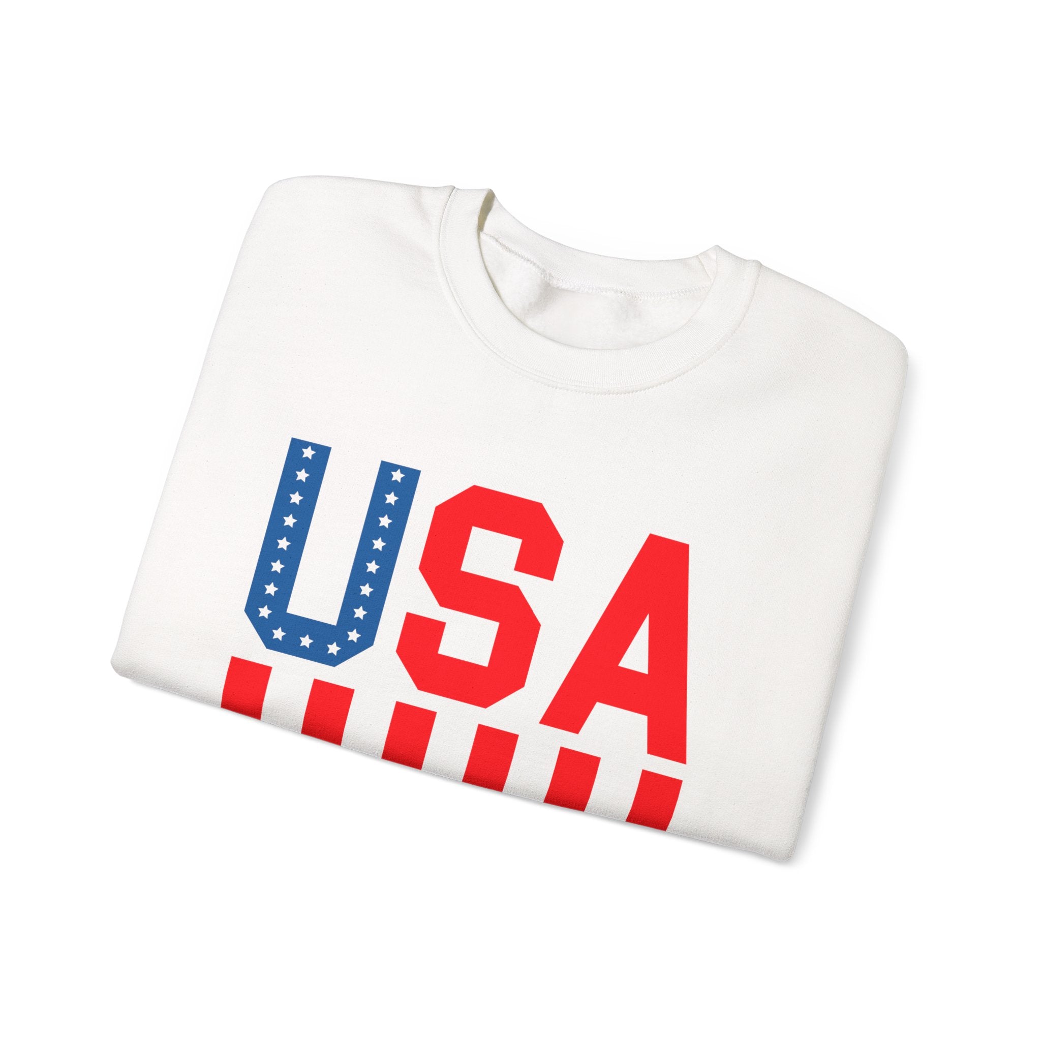 A folded white crewneck sweatshirt featuring a bold 'USA' graphic on the front. The letter 'U' is filled with a blue field of white stars, while 'S' and 'A' are solid red.