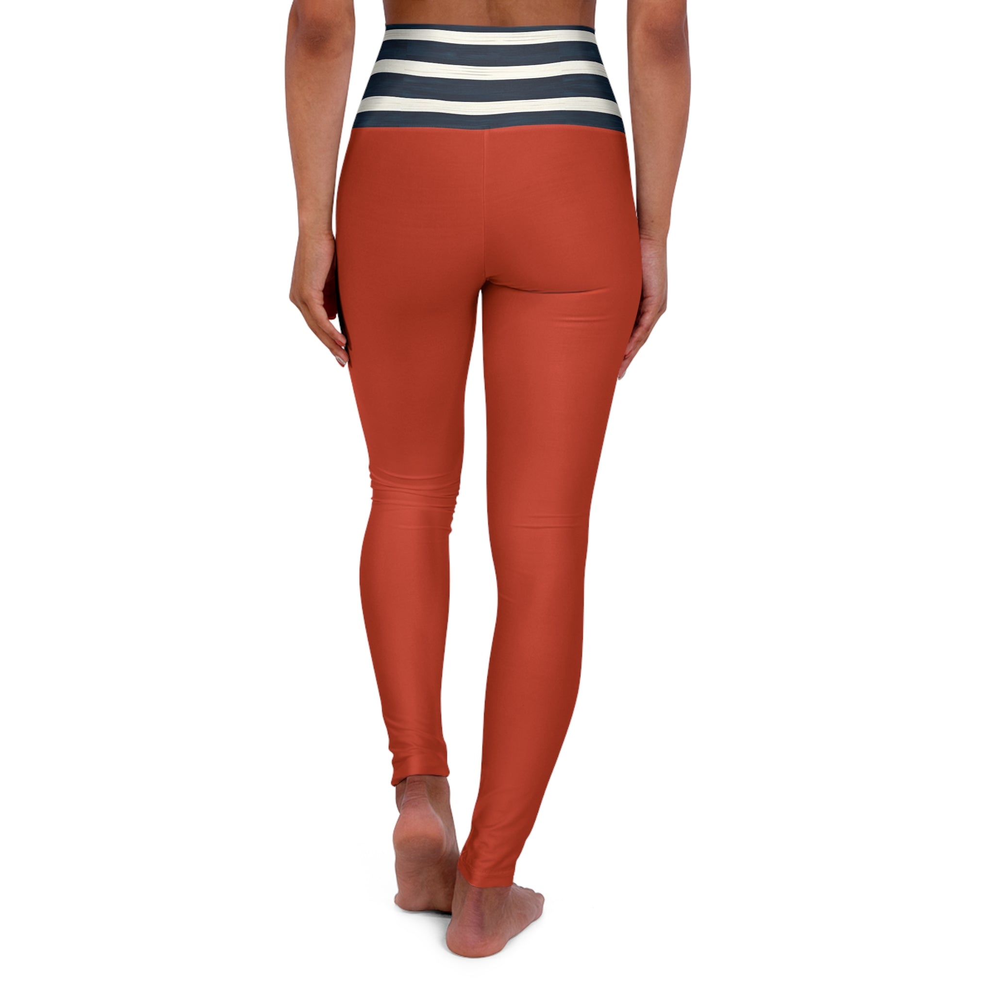 Rust orange high-waisted leggings with a navy and white striped waistband, shown on a model from the back against a white background.