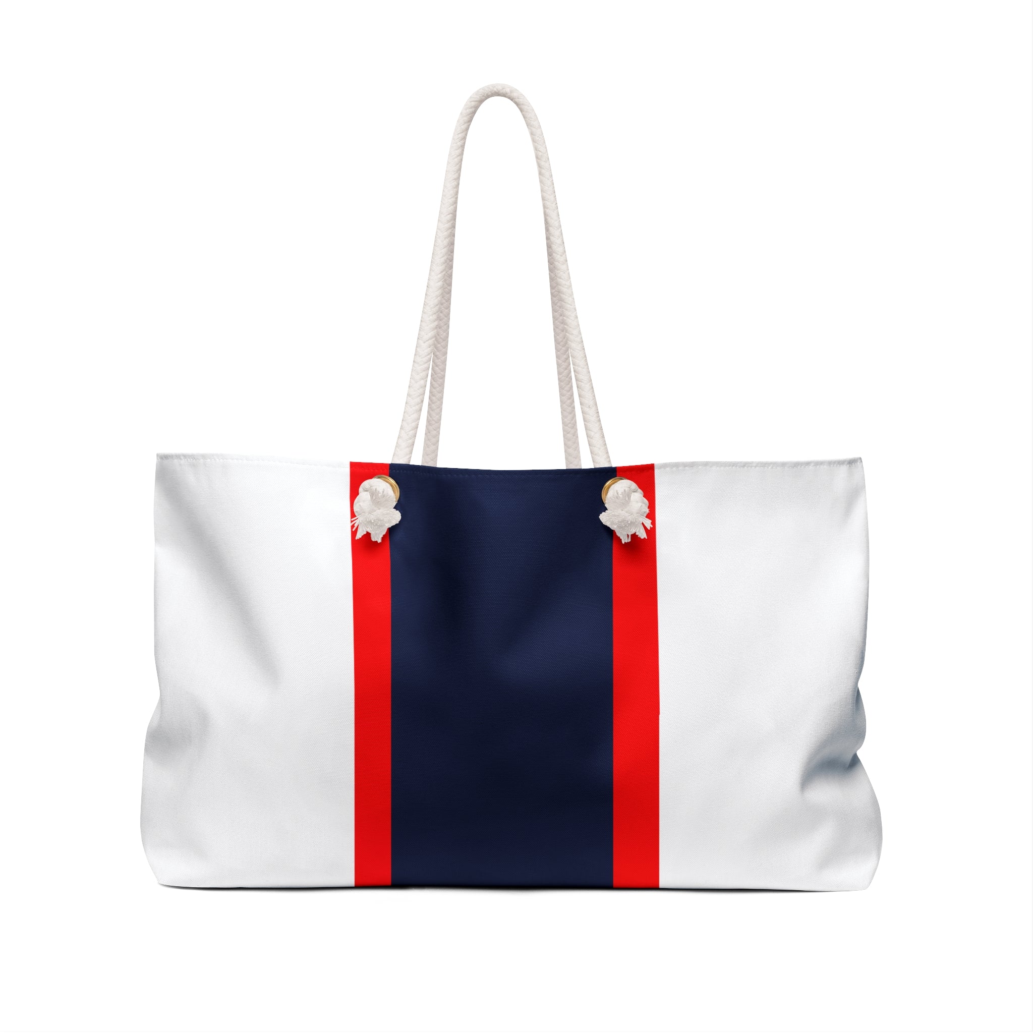 A white canvas tote bag with a navy blue center panel and two vertical red stripes flanking the panel, featuring white rope handles and white shell-like decorative accents at the top.