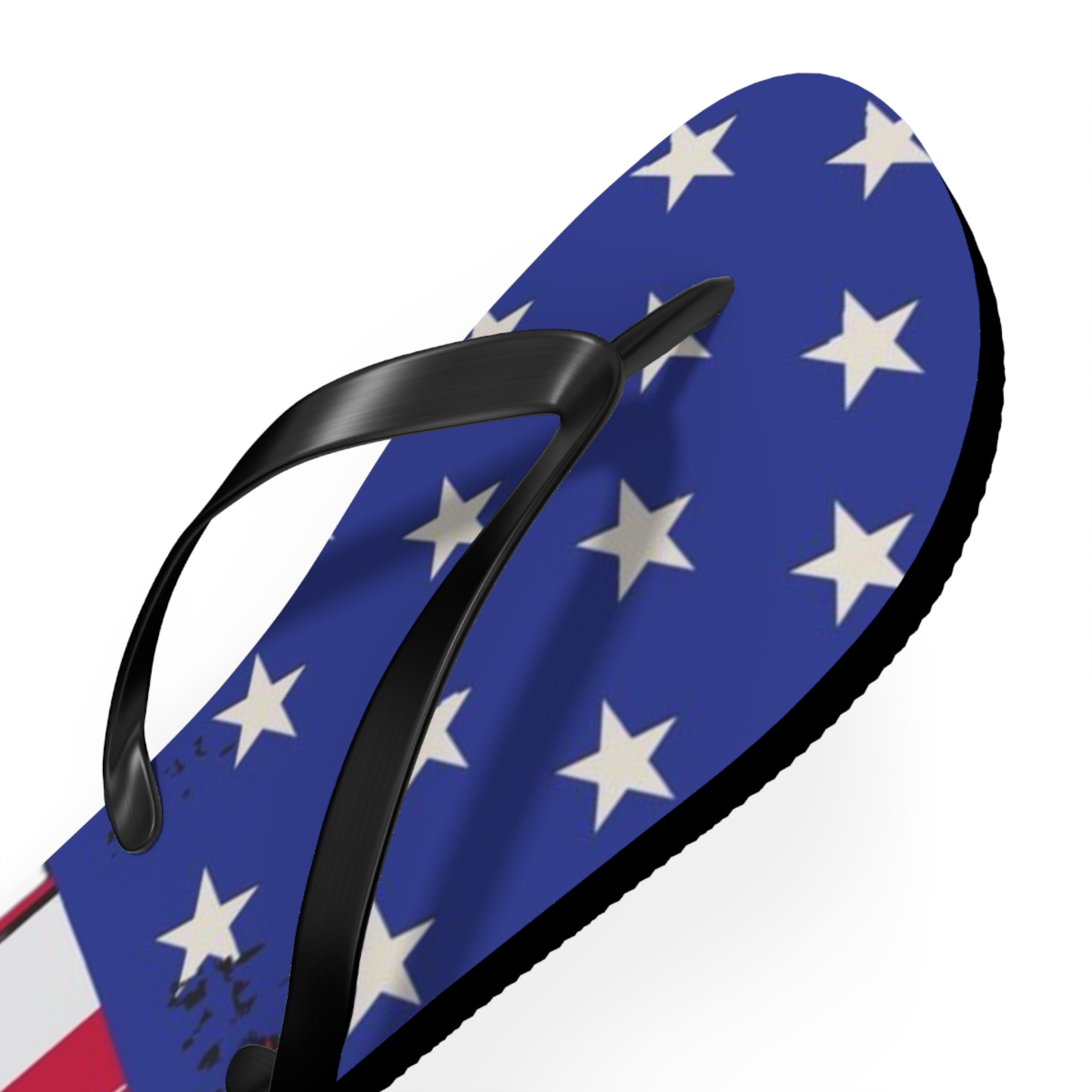 A single flip-flop sandal shown at an angle on a plain white background. The footbed has an American flag-inspired pattern with white stars on a blue field, and the thong strap is black.