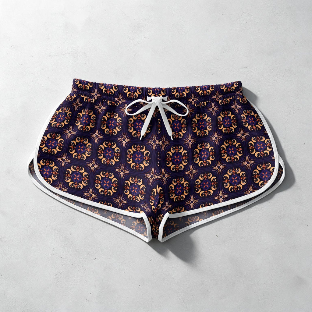Patterned athletic shorts with a white drawstring and white piping trim, laid flat on a light gray textured background.
