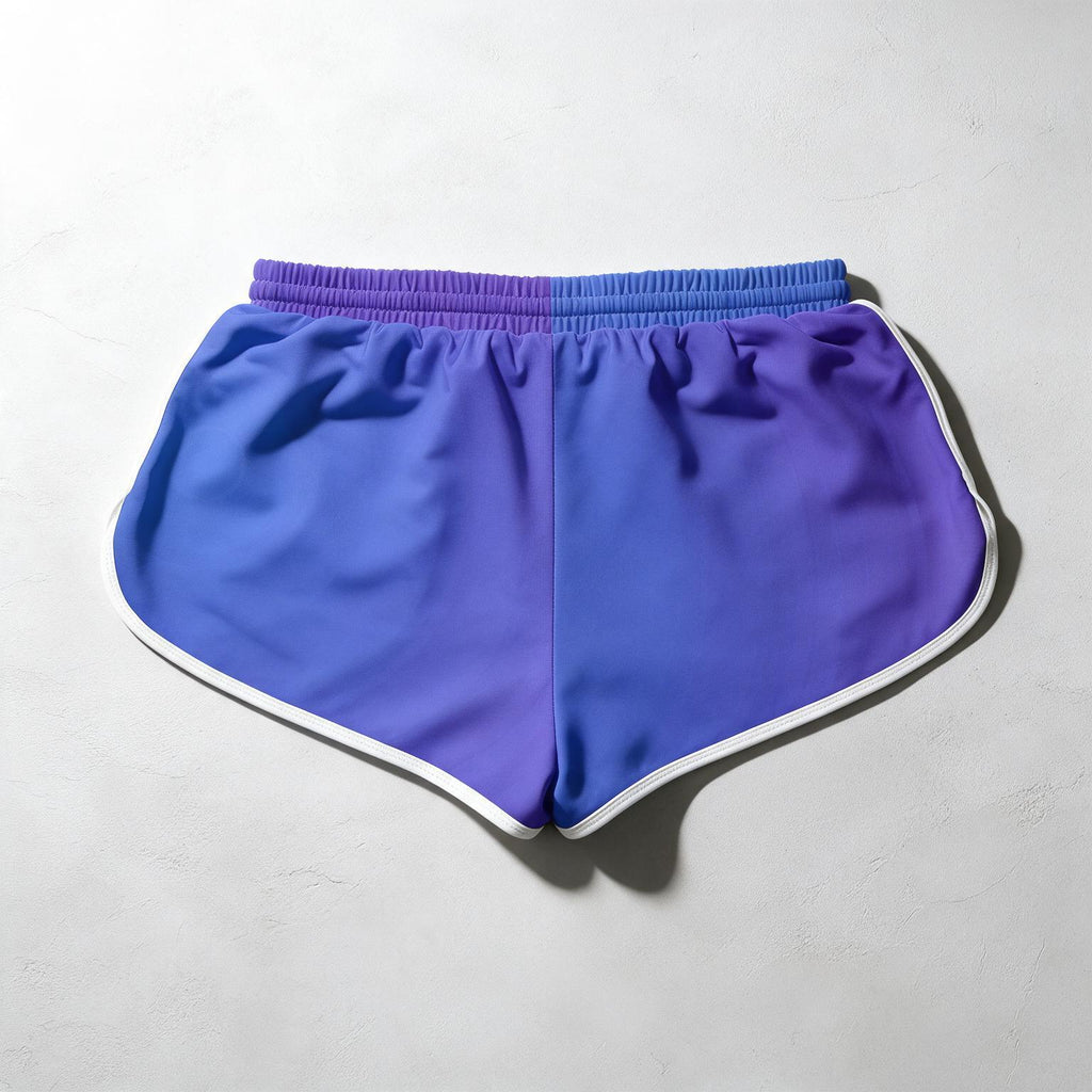 A pair of athletic shorts featuring a smooth color gradient transitioning from blue to purple, finished with a white piping trim along the curved hem and waistband.