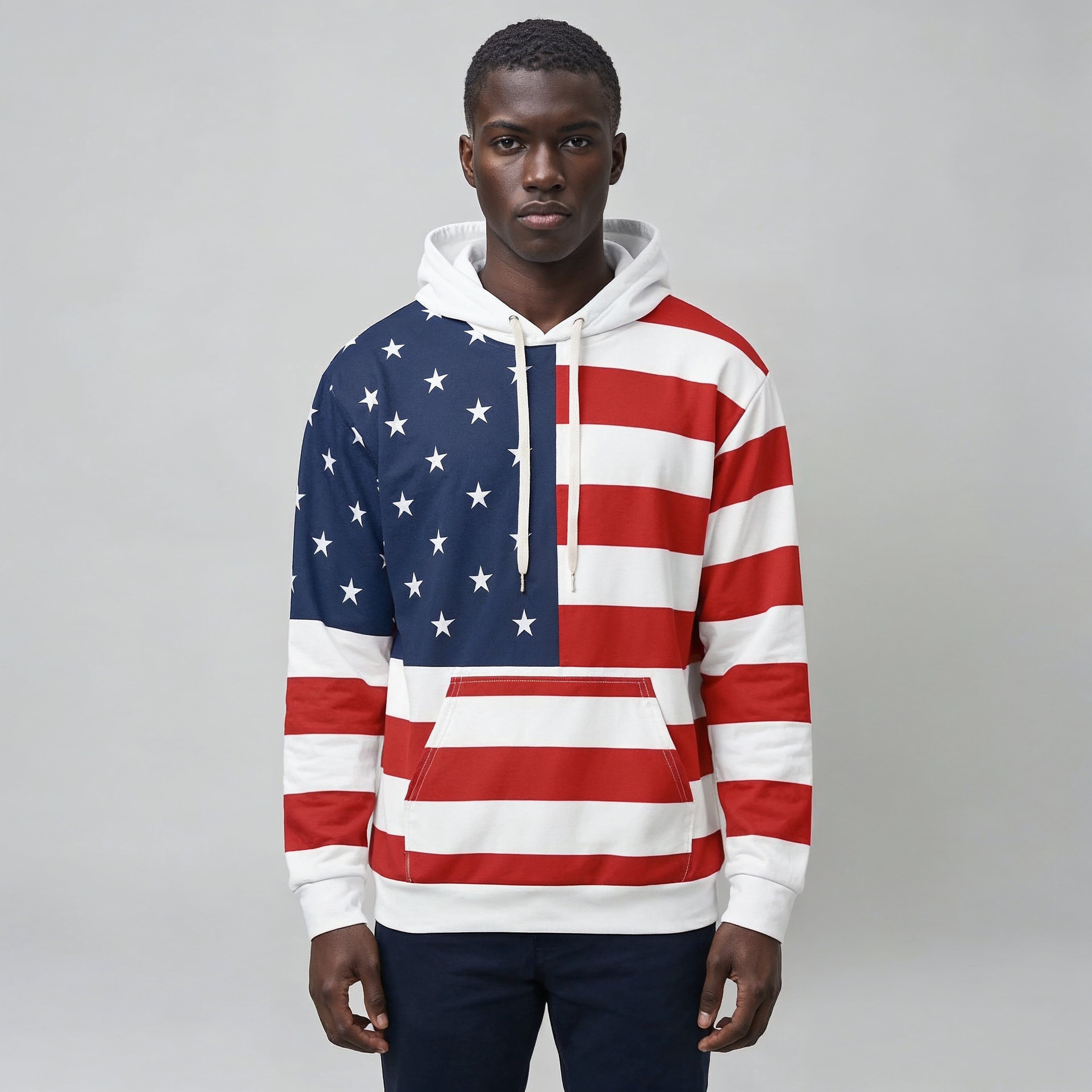 Person wearing a hoodie with an American flag design on a plain background