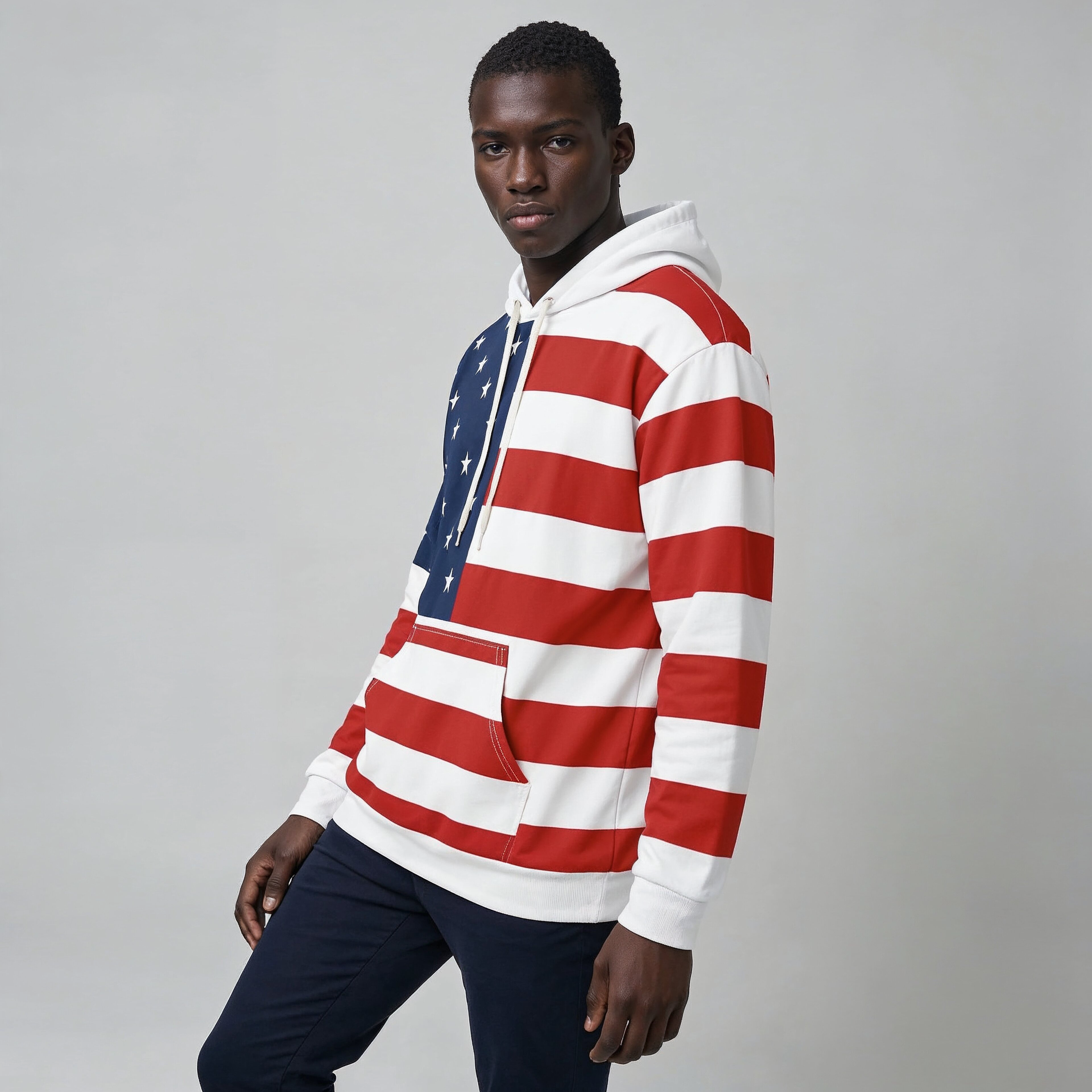 Person wearing a red, white, and blue striped hoodie on a plain background