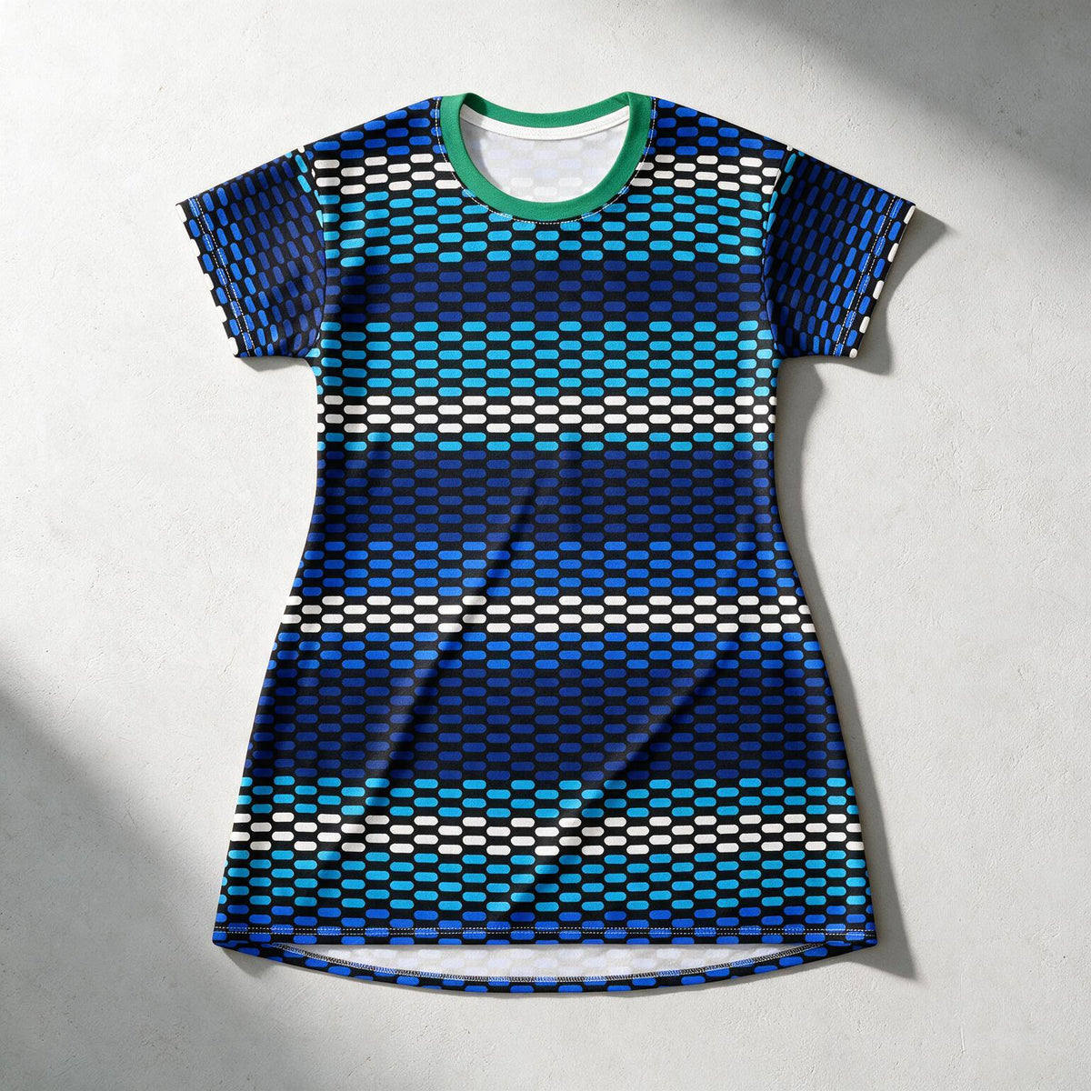 A short-sleeve athletic t-shirt with a geometric pattern of horizontal stripes in navy, blue, teal, and white. It features a contrasting green crew neck collar and is laid flat on a light gray textured background.