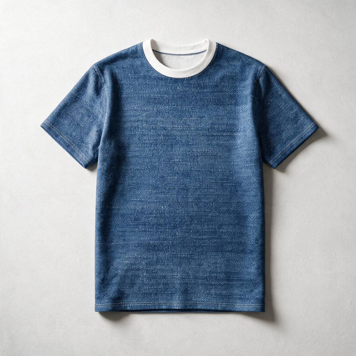 A blue short-sleeve crewneck t-shirt with a contrasting white ribbed collar, laid flat against a light gray textured background.