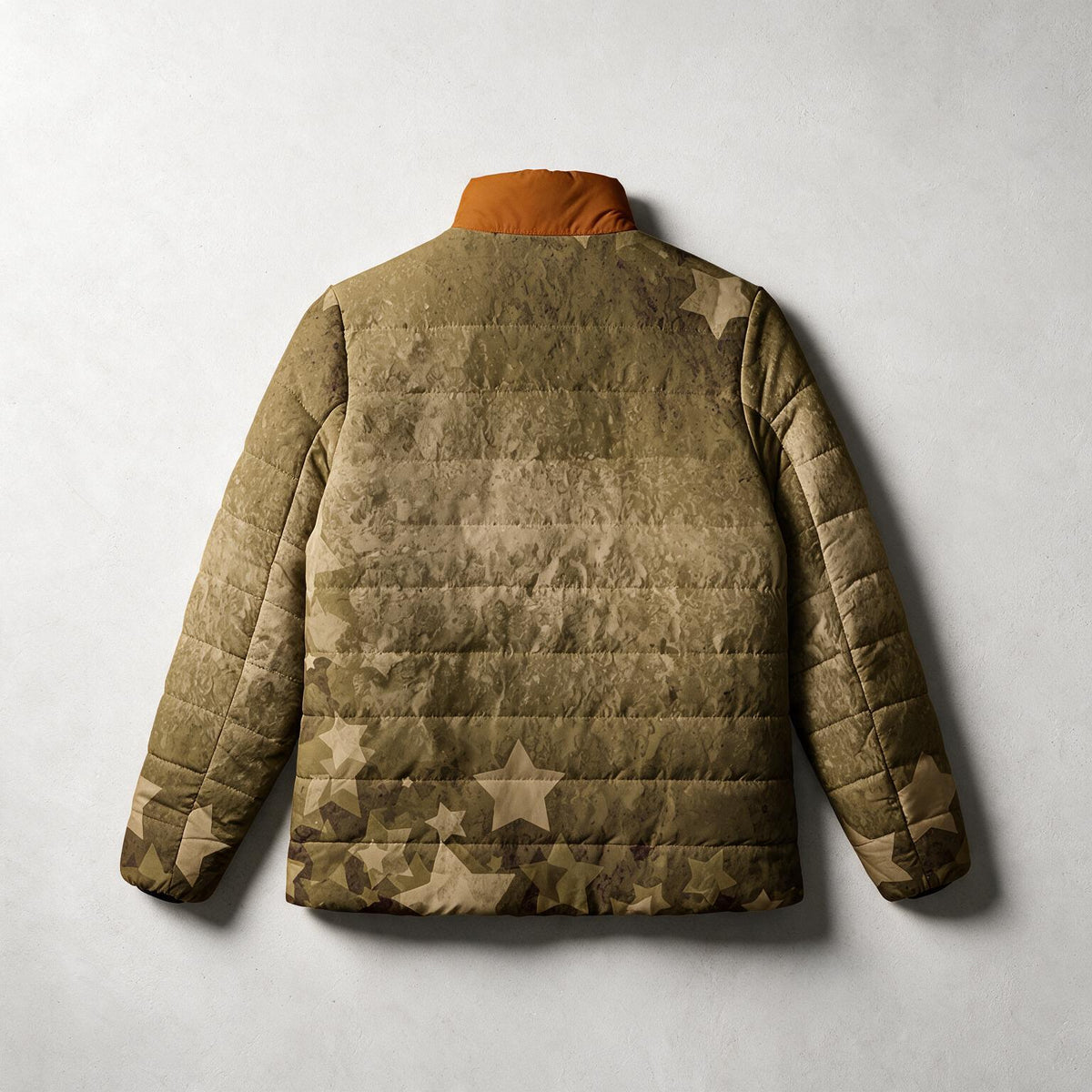 A quilted puffer jacket shown from the back, featuring a distressed camouflage pattern in olive green, brown, and tan with a solid orange-brown collar, displayed against a light gray textured background.