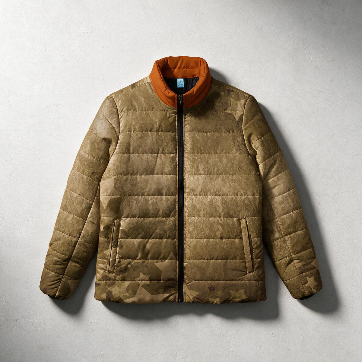 A brown quilted puffer jacket with a star pattern, featuring a contrasting orange collar, shown flat against a textured gray background.