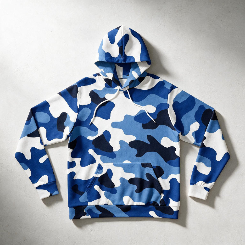 A blue and white camouflage pullover hoodie with white drawstrings, laid flat on a light gray textured background.