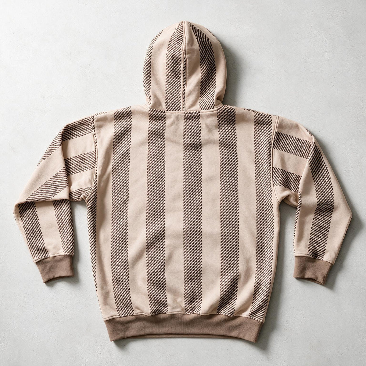 A beige and brown striped hoodie shown from the back, laid flat on a light gray background.