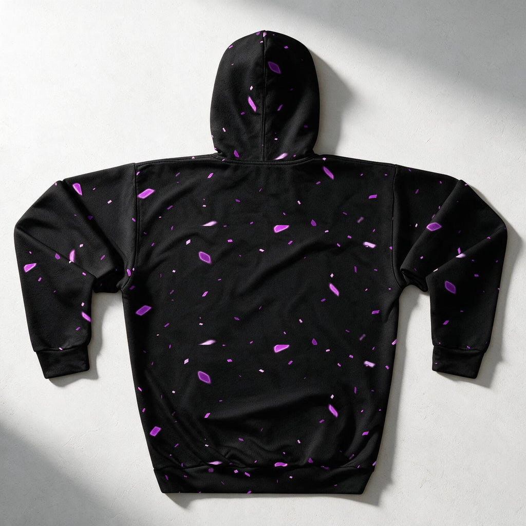 A black hooded sweatshirt shown from the back, featuring a scattered purple and magenta abstract speckle pattern, laid flat on a light gray background with soft shadows.