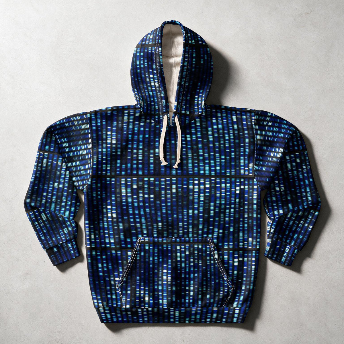 A blue and black patterned pullover hoodie with white drawstrings, laid flat on a light gray textured background.