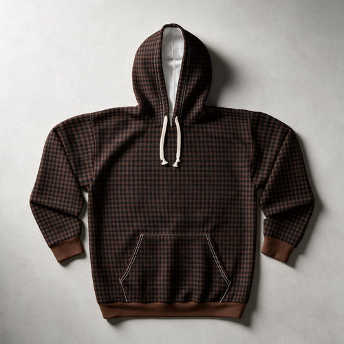 A dark brown and black checkered pullover hoodie with white drawstrings and a white-lined hood, laid flat on a light gray background.
