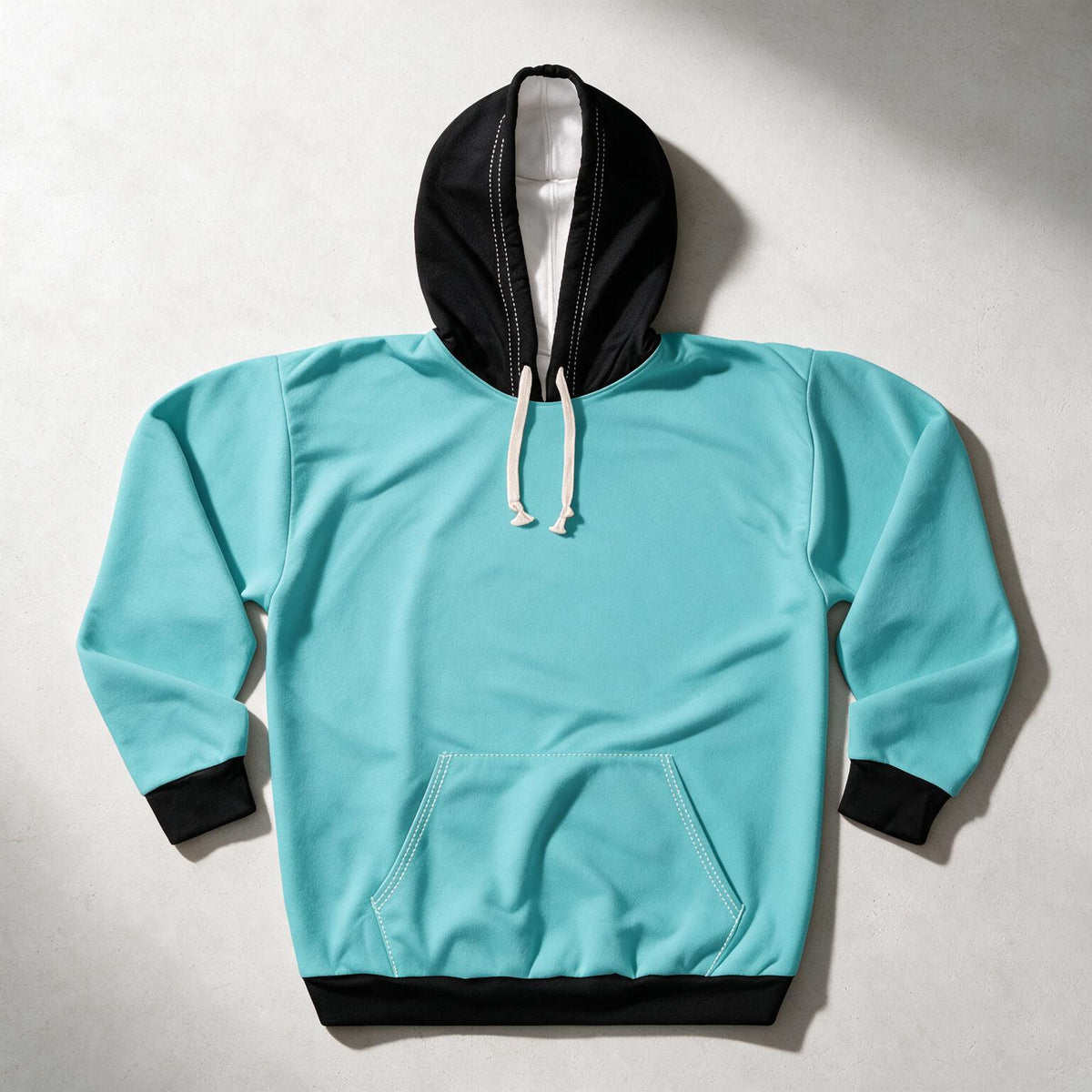A turquoise pullover hoodie with a black hood, black drawstrings, and black ribbed trim, laid flat on a light gray background.
