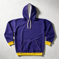 A purple pullover hoodie with yellow ribbed cuffs, hem, and pocket trim, featuring white drawstrings, laid flat on a light gray background.