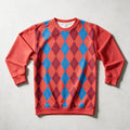 A crewneck sweatshirt with a red, blue, and purple argyle pattern on the front and solid red sleeves, laid flat on a light gray background.