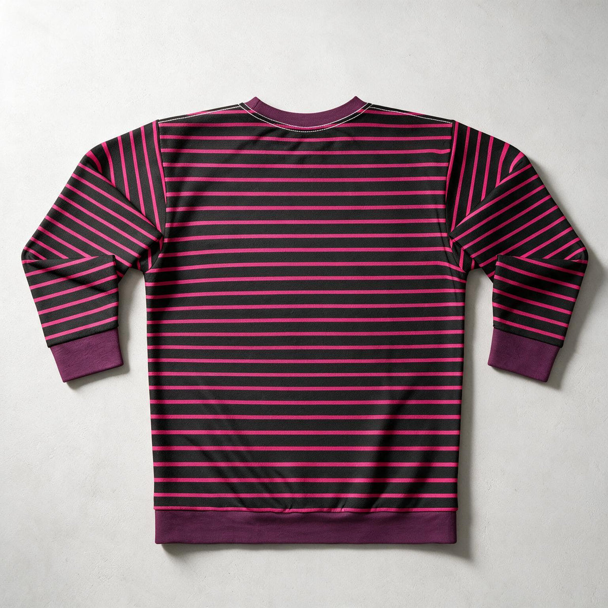 A long-sleeve crewneck sweatshirt shown from the back, featuring horizontal stripes in dark purple and bright magenta pink, with solid dark purple ribbed cuffs, collar, and hem.