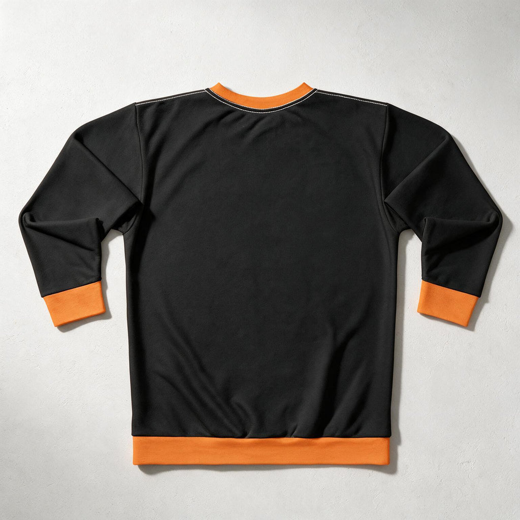 A black long-sleeve crewneck sweatshirt shown from the back, featuring contrasting bright orange ribbed trim at the collar, cuffs, and hem, laid flat on a light gray textured background.