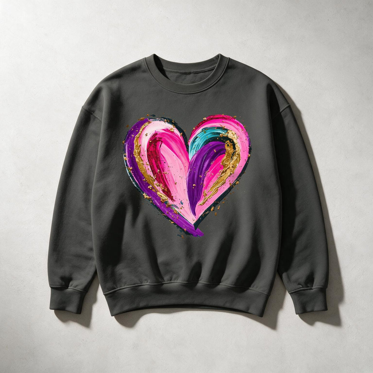 A dark gray crewneck sweatshirt featuring a large, vibrant, multicolored abstract heart graphic on the chest, displayed flat against a light gray textured background.