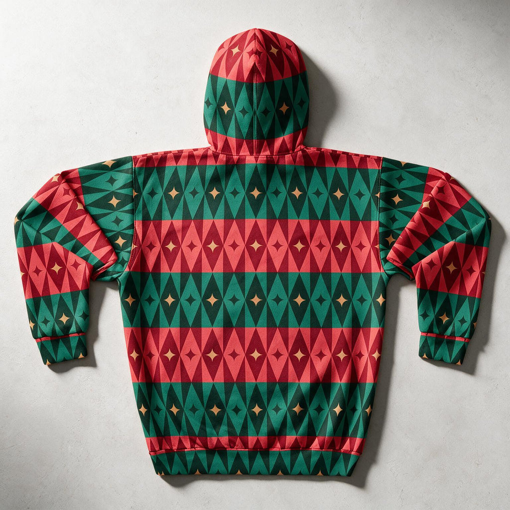 A hooded sweatshirt laid flat on a light gray surface, featuring a festive geometric pattern with alternating horizontal bands of red, dark green, and black triangles, accented with small gold stars.
