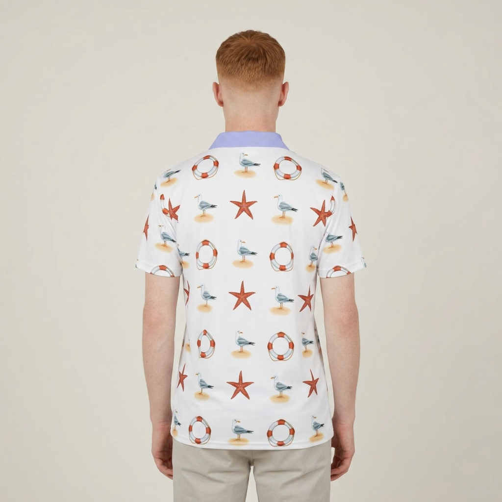 A man viewed from behind wearing a white short-sleeve polo shirt with a colorful nautical print of starfish, seagulls, life buoys, and boats, paired with light beige trousers against a plain beige background.