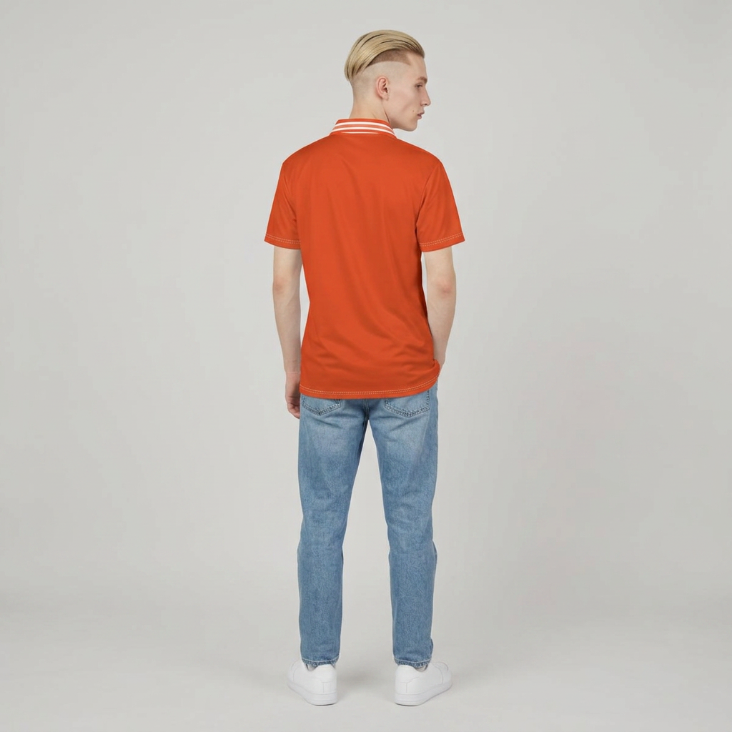 A man viewed from the back wearing a bright orange short-sleeve polo shirt with white stripes on the collar, paired with light blue jeans and white sneakers, against a plain light gray studio background.